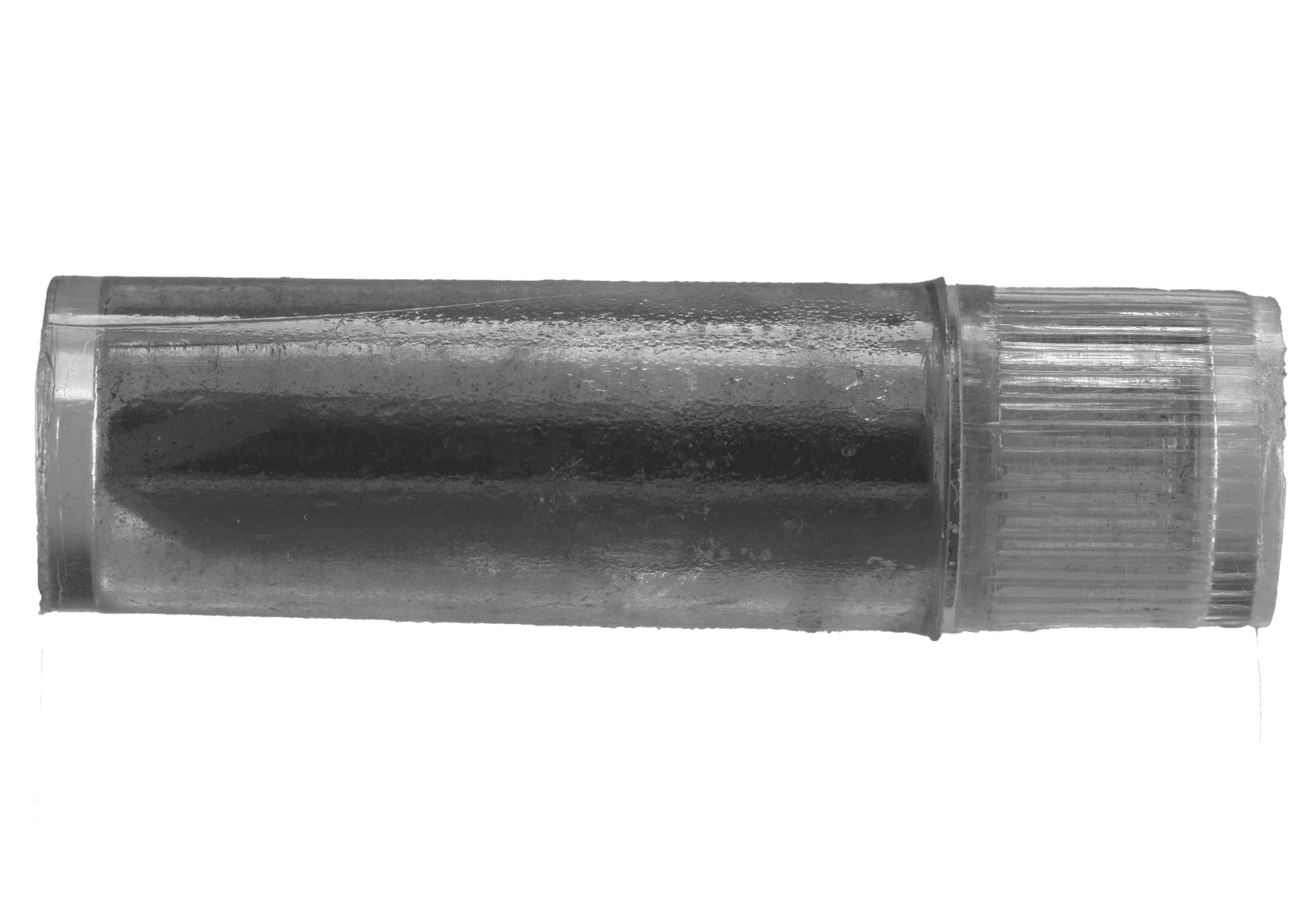 Round glass container filled with graphite.